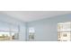 Bright bedroom with large windows and light blue walls at 3426 79Th Street W Cir # 202, Bradenton, FL 34209