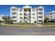 Three-story building with light-colored exterior and a spiral staircase at 3426 79Th Street W Cir # 202, Bradenton, FL 34209