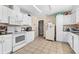 Cozy kitchen with white cabinets and granite counters at 512 1St E Ave, Bradenton, FL 34208