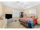 Bright bedroom with a king-size bed and a large TV at 512 1St E Ave, Bradenton, FL 34208