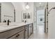 Double vanity bathroom with modern fixtures and arched mirrors at 5289 Cappleman Loop, Brooksville, FL 34601