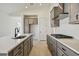 Modern kitchen with gray cabinets, island, and stainless steel appliances at 5289 Cappleman Loop, Brooksville, FL 34601