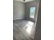 Bright bedroom with wood-look floors and ceiling fan at 11261 3Rd Ave, Punta Gorda, FL 33955