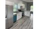 Modern kitchen, stainless steel appliances, white cabinets and teal dishwasher at 11261 3Rd Ave, Punta Gorda, FL 33955