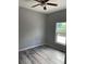 Bright bedroom with wood-look floors and ceiling fan at 11261 3Rd Ave, Punta Gorda, FL 33955