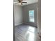 Spacious bedroom featuring wood-look floors and a ceiling fan at 11261 3Rd Ave, Punta Gorda, FL 33955