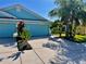 Light blue house with a three-car garage and nicely landscaped front yard at 11420 Captiva Kay Dr, Riverview, FL 33569
