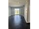 Living room with dark flooring, view of backyard at 11420 Captiva Kay Dr, Riverview, FL 33569