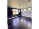 Large bedroom with dark floors, two-toned walls, and a chandelier at 11420 Captiva Kay Dr, Riverview, FL 33569