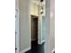 Hallway with dark floors and access to multiple rooms at 11420 Captiva Kay Dr, Riverview, FL 33569