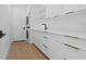 Modern laundry room with stacked washer/dryer and white cabinets at 2165 Rose St, Sarasota, FL 34239