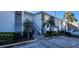 Modern condo building with parking and lush landscaping at 1046 W Peppertree Ln # 115B, Sarasota, FL 34242