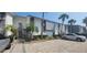 Modern condo building with ample parking and landscaping at 1046 W Peppertree Ln # 115B, Sarasota, FL 34242