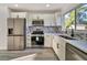 Modern kitchen with stainless steel appliances and white cabinets at 3875 Pan American Blvd, North Port, FL 34287
