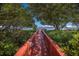 Walkway to waterfront dock, shaded by lush landscaping at 1801 Gulf N Dr # 248, Bradenton Beach, FL 34217