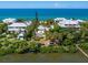 Waterfront home nestled amongst tropical foliage, offering a private dock at 426 N Casey Key Rd, Osprey, FL 34229