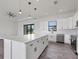 Modern kitchen with white cabinets, quartz countertops, and stainless steel appliances at 200 Redwood Rd, Rotonda West, FL 33947