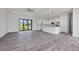 Open-concept living area with gray tile floors and a view of the kitchen at 200 Redwood Rd, Rotonda West, FL 33947
