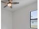 Well-lit bedroom featuring a ceiling fan and large window at 200 Redwood Rd, Rotonda West, FL 33947
