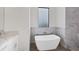 Spa-like bathroom with a modern freestanding tub and a window at 200 Redwood Rd, Rotonda West, FL 33947