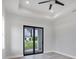 Bright bedroom with gray floors and sliding glass doors at 200 Redwood Rd, Rotonda West, FL 33947