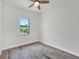 Bright bedroom with wood-look floors and large window at 200 Redwood Rd, Rotonda West, FL 33947