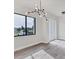 Modern dining room featuring a unique chandelier and large window at 200 Redwood Rd, Rotonda West, FL 33947