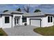 Modern single-Gathering home with gray paver driveway at 200 Redwood Rd, Rotonda West, FL 33947