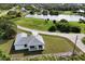 Aerial view of a house near a lake in a residential area at 200 Redwood Rd, Rotonda West, FL 33947