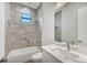 Clean bathroom, featuring a bathtub, modern vanity, and marble-look tile at 200 Redwood Rd, Rotonda West, FL 33947
