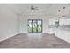Open living space with kitchen and sliding glass doors leading outside at 200 Redwood Rd, Rotonda West, FL 33947