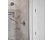 Modern shower with marble-look tile and a frameless glass enclosure at 200 Redwood Rd, Rotonda West, FL 33947