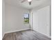 Spacious bedroom with wood-look floors, window, and white sliding doors at 200 Redwood Rd, Rotonda West, FL 33947