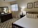 Bedroom featuring a double bed, dresser, and rug at 6201 Green View Dr # 130, Sarasota, FL 34231