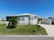 Charming single story home with a well-maintained lawn, carport and palm tree at 1532 46Th Avenue E Dr, Ellenton, FL 34222