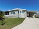 Charming single story home with a well-maintained lawn, carport and palm tree at 1532 46Th Avenue E Dr, Ellenton, FL 34222
