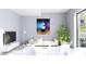 Living room with comfy sofa, large artwork, and TV at 2170 Robinhood Street # C1-312, Sarasota, FL 34231