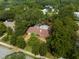Single story home surrounded by mature trees, with a large backyard at 1713 North Dr, Sarasota, FL 34239