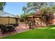 Large backyard with patio, pergola, and lush greenery at 1713 North Dr, Sarasota, FL 34239