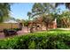 Large backyard with patio, pergola, and lush greenery at 1713 North Dr, Sarasota, FL 34239