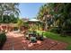Landscaped backyard with patio, seating area, and lush greenery at 1713 North Dr, Sarasota, FL 34239