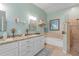 Elegant bathroom with double vanity, soaking tub, and walk-in shower at 1713 North Dr, Sarasota, FL 34239