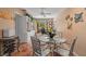Charming breakfast nook with glass table and chairs, adjacent to kitchen at 1713 North Dr, Sarasota, FL 34239