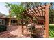 Courtyard with brick flooring, fountain, pergola, and seating at 1713 North Dr, Sarasota, FL 34239