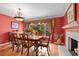 Formal dining room with a fireplace and rich color palette at 1713 North Dr, Sarasota, FL 34239