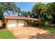 Two-car garage with a large driveway and mature trees at 1713 North Dr, Sarasota, FL 34239