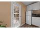 Small kitchen with white cabinets and view to backyard patio at 1713 North Dr, Sarasota, FL 34239
