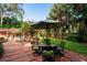 Outdoor patio dining area with seating and umbrella at 1713 North Dr, Sarasota, FL 34239