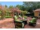 Brick patio with pergola, fire pit, and seating area at 1713 North Dr, Sarasota, FL 34239