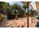Relaxing side patio with stone flooring and lush landscaping at 1713 North Dr, Sarasota, FL 34239